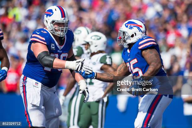 Eric Wood of the Buffalo Bills congratulates Mike Tolbert on a touchdown during the game against the New York Jets on September 10, 2017 at New Era...