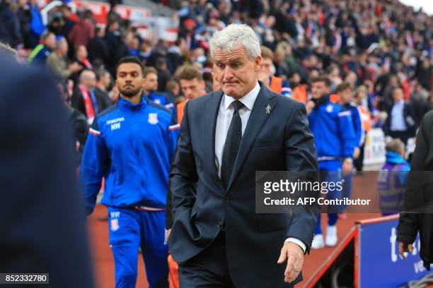 Stoke City's Welsh manager Mark Hughes reacts as he leaves the touchline during the English Premier League football match between Stoke City and...