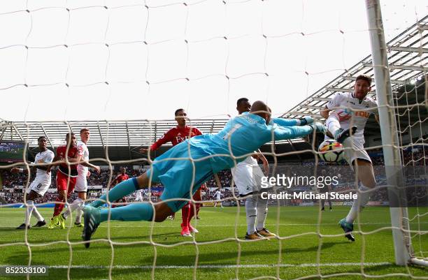 Heurelho Gomes of Watford saves a shot from Federico Fernandez of Swansea City during the Premier League match between Swansea City and Watford at...