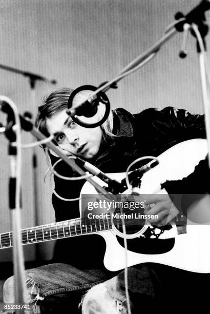 Photo of NIRVANA and Kurt COBAIN, Kurt Cobain, posed, looking to camera, recording in Hilversum Studios, with acoustic guitar