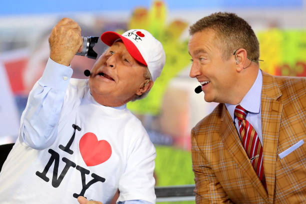 College Gameday analysts Lee Corso and Kirk Herbstreit pose on set at Times Square on September 23, 2017 in New York City.