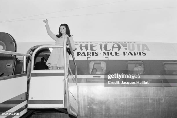 French singer Sheila waves to the crowd during her arrival at the Cannes airport.