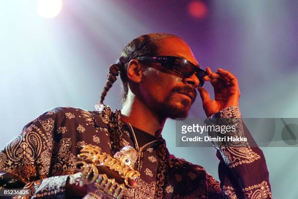 Photo of SNOOP DOGG, performing live onstage, with jewelled microphone