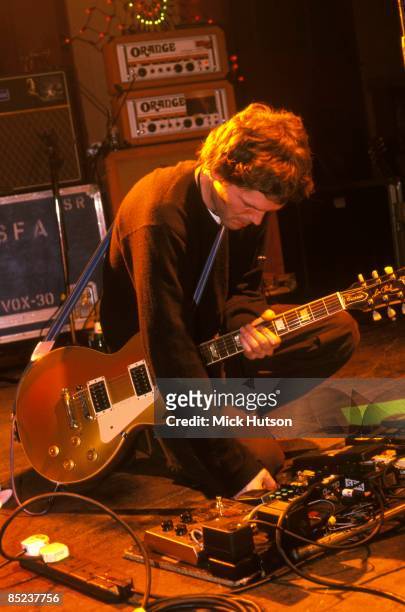 Photo of ROADIES; Guitarist using guitar effects pedals on stage