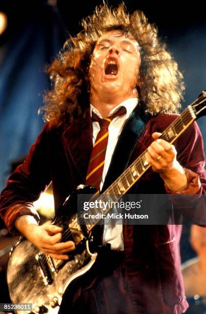 Photo of AC DC and Angus YOUNG and AC/DC, Angus Young performing live onstage, playing Gibson SG guitar