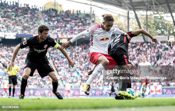 Yussuf Poulsen of RB Leipzig in action with David Angel Abraham of Eintracht Frankfurt and Timothy Chandler of Eintracht Frankfurt during the...