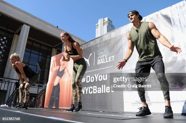 Trainers leading a workout on stage at the first ever workout session in Lincoln Center hosted by PUMA & New York City Ballet on September 23, 2017...