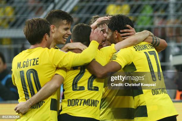 Maximilian Philipp of Dortmund celebrates with team mates after he scored his teams first goal to make it 1:0 during the Bundesliga match between...