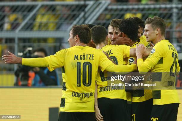 Maximilian Philipp of Dortmund celebrates with team mates after he scored his teams first goal to make it 1:0 during the Bundesliga match between...