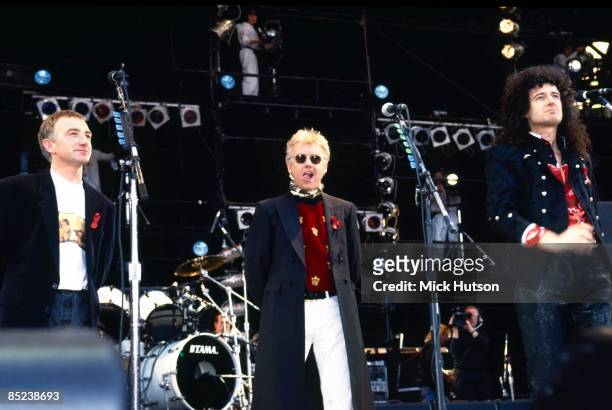 Photo of QUEEN, John Deacon, Roger Taylor and Brian May on stage at the Freddie Mercury tribute concert