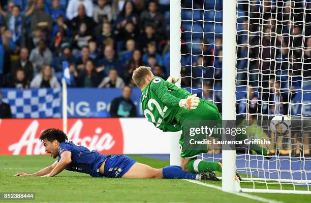 Simon Mignolet of Liverpool attempts to save as Shinji Okazaki of Leicester City scores his sides first goal during the Premier League match between...