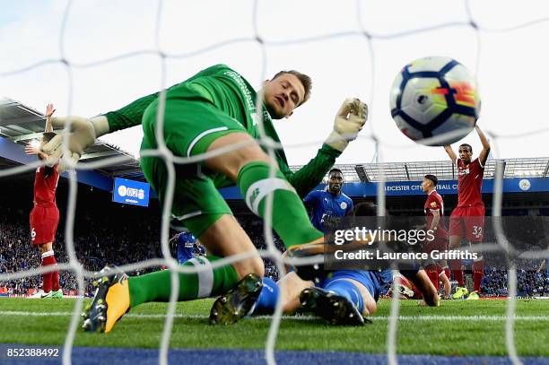 Simon Mignolet of Liverpool attempts to save as Shinji Okazaki of Leicester City scores his sides first goal during the Premier League match between...