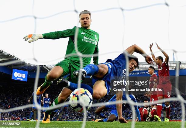 Simon Mignolet of Liverpool attempts to save as Shinji Okazaki of Leicester City scores his sides first goal during the Premier League match between...