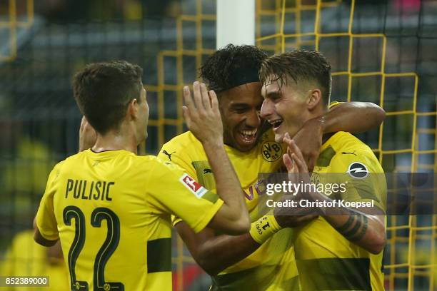 Pierre-Emerick Aubameyang of Dortmund celebrates with Maximilian Philipp of Dortmund and Mario Goetze of Dortmund after he scored his teams third...