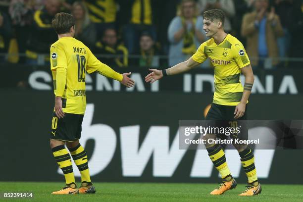 Maximilian Philipp of Dortmund celebrates with Mario Goetze of Dortmund after he scored his teams first goal to make it 1:0 during the Bundesliga...