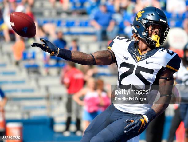 Justin Crawford of the West Virginia Mountaineers tosses the ball as he celebrates his second quarter touchdown against the Kansas Jayhawks at...