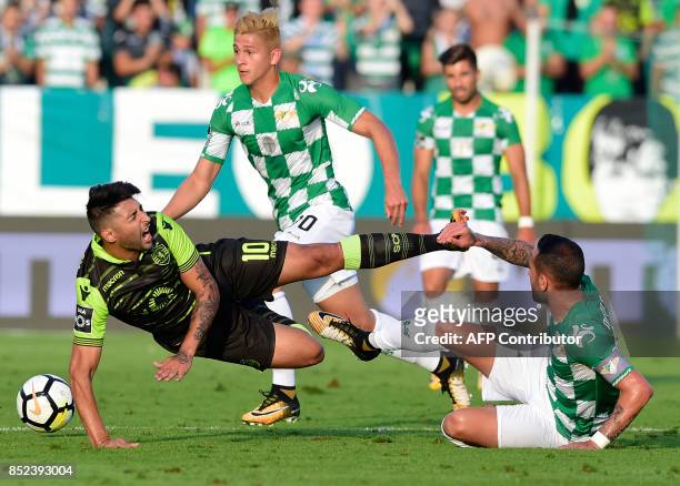 Sporting's Argentinian forward Alan Ruiz is tackled by Moreirense's Brazilian midfielder Angelo Neto during the Portuguese league football match...