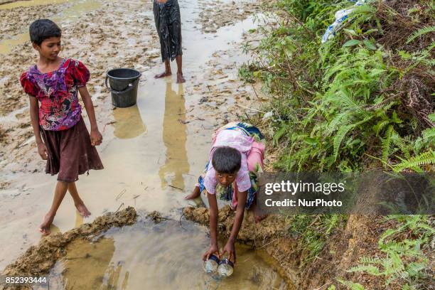 Balukhali camp resident collects drinking water from mud and clay as the supply of drinking water is inadequate. They dug a 3 to 4 feet circular or...