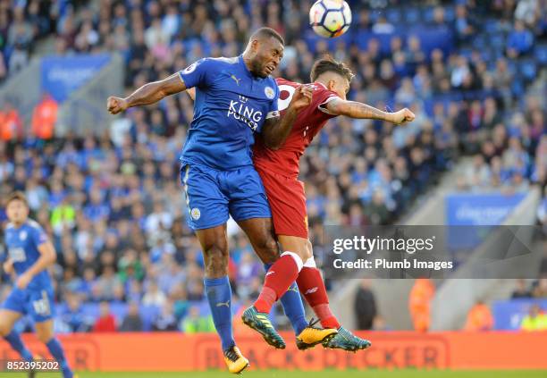 Wes Morgan of Leicester City competes for a header Roberto Firmino of Liverpool during the Premier League match between Leicester City and Liverpool...