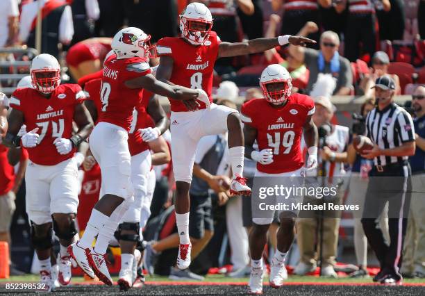 Lamar Jackson of the Louisville Cardinals celebrates with Malik Williams after a touchdown against the Kent State Golden Flashes during the first...