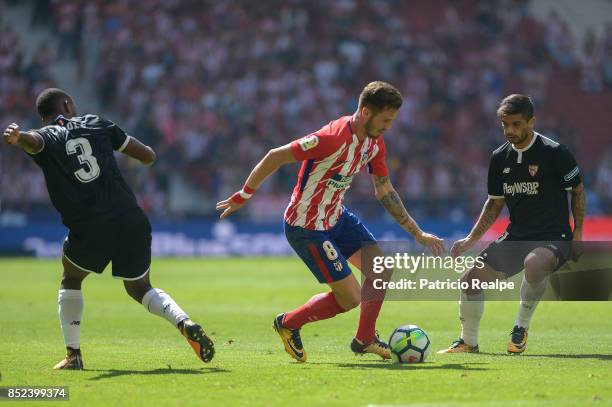 Saul Ñiguez of Atletico de Madrid fights for the ball with Lionel Carole of Sevilla during the match between Atletico de Madrid and Sevilla as part...