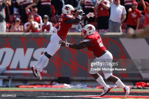 Trumaine Washington of the Louisville Cardinals celebrates with Henry Famurewa after returning a interception for a touchdown against the Kent State...