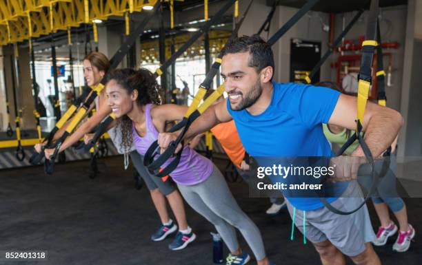 group of people suspension training at the gym - suspension training stock pictures, royalty-free photos & images