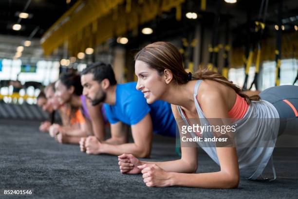 groep mensen op de sportschool in een schorsing opleiding klasse - plank exercise stockfoto's en -beelden