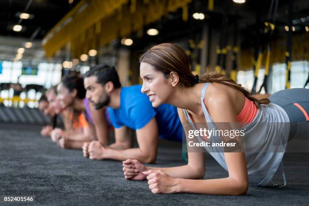 group of people at the gym in a suspension training class - manufactured object stock pictures, royalty-free photos & images