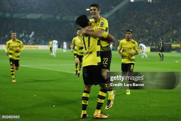 Pierre-Emerick Aubameyang of Dortmund celebrates with Christian Pulisic of Dortmund after he scored his teams fifth goal to make it 5:0 during the...