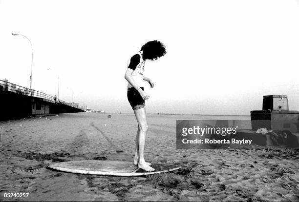Photo of RAMONES; Joey Ramone standing on a surfboard at Coney Island
