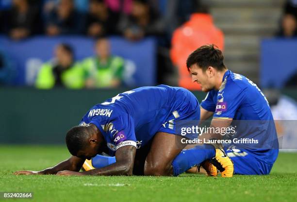 Wes Morgan of Leicester City and Harry Maguire of Leicester City look dejected after liverpool score their third goal during the Premier League match...