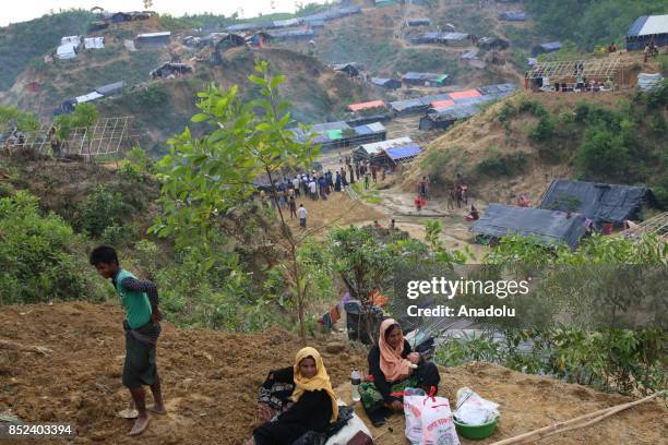 Rohingya Muslim women sit on the ground at a makeshift camp in Teknaff, Bangladesh on September 23, 2017. Violence erupted in Myanmars Rakhine state...