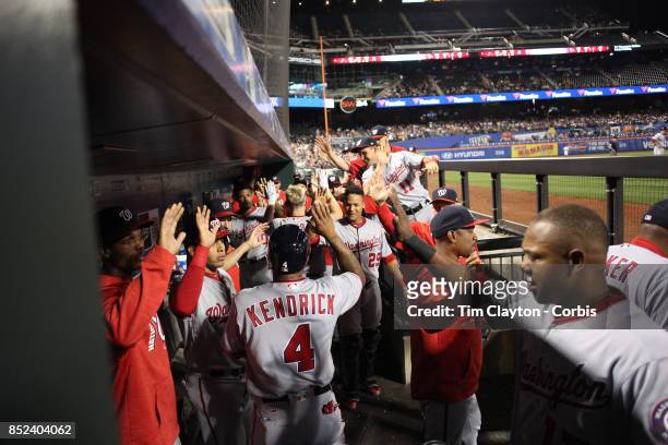 Adam Lind of the Washington Nationals is congratulated by team mates as he returns to the dugout after hitting a three run home run in the third...