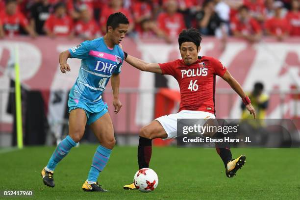 Yuji Ono of Sagan Tosu takes on Ryota Moriwaki of Urawa Red Diamonds during the J.League J1 match between Urawa Red Diamonds and Sagan Tosu at...