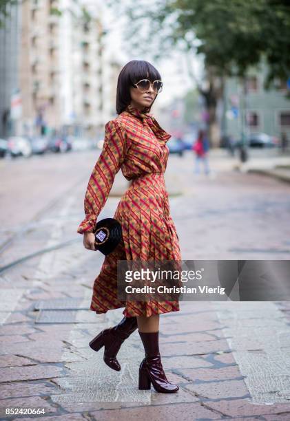 Kat Graham wearing YSL dress, Marc Jacobs ankle boots, Sarah clutch, Dior sunglasses is seen during Milan Fashion Week Spring/Summer 2018 on...