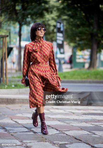 Kat Graham wearing YSL dress, Marc Jacobs ankle boots, Sarah clutch, Dior sunglasses is seen during Milan Fashion Week Spring/Summer 2018 on...