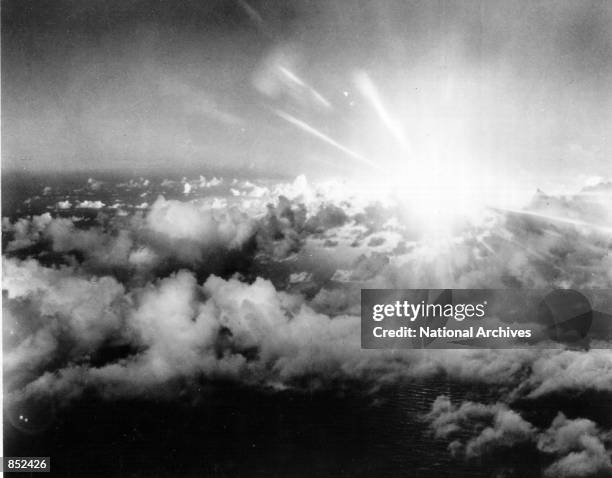 The flash from the "Baker Day" blast July 25, 1946 is photographed from the air at Bikini Island in the Pacific.