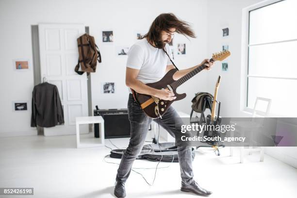 man playing electric guitar - head banging stock pictures, royalty-free photos & images
