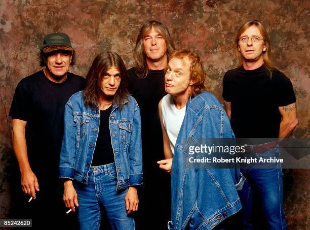 Photo of AC/DC; L-R: Brian Johnson, Malcolm Young, Cliff Williams, Angus Young, Phil Rudd, posed, studio, group shot at Rockwalk Induction