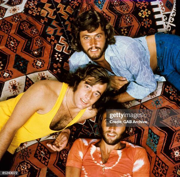 Photo of BEE GEES posed in 1971. Top to bottom: Barry Gibb, Robin Gibb, Maurice Gibb.