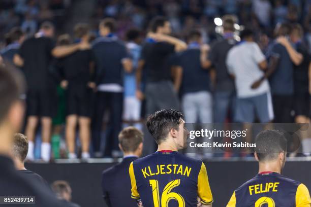 Sacha Kljestan of New York Red Bulls looks on as Sporting Kansas City players lift the US Open Cup after the final match at Children's Mercy Park on...