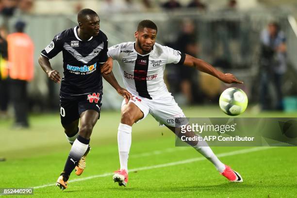 Guingamp's French defender Marcus Coco vies with Bordeaux's French defender Youssouf Sabaly during the French Ligue 1 football match between Bordeaux...