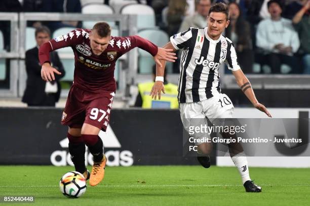 Lyanco Evangelista of Torino and Paulo Dybala of Juventus compete for the ball during the Serie A match between Juventus and Torino FC on September...