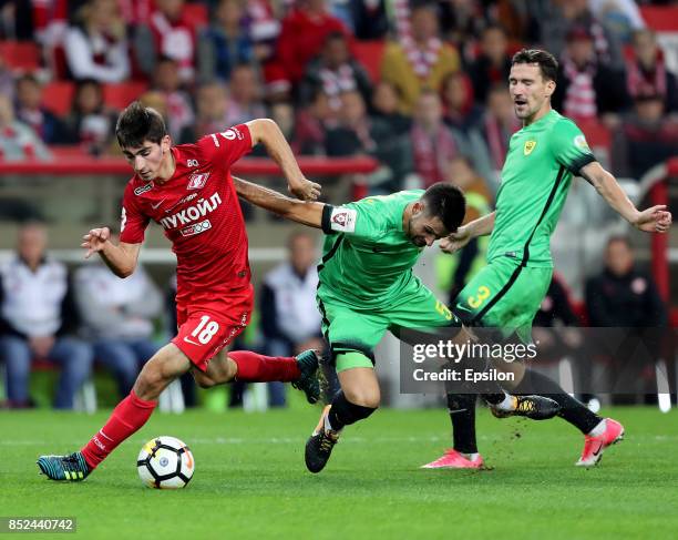 Zelimkhan Bakayev of FC Spartak Moscow vies for the ball with Miral Samardzic and Vladimir Poluyakhtov of FC Anzhi Makhachkala during the Russian...