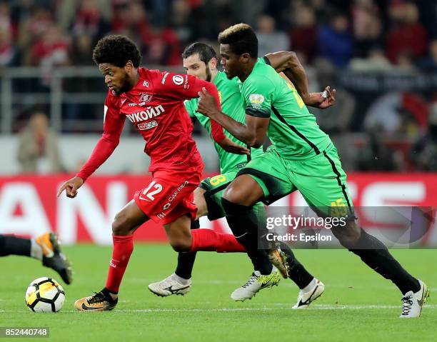 Luiz Adriano of FC Spartak Moscow vies for the ball with Thomas Phibel of FC Anzhi Makhachkala during the Russian Premier League match between FC...