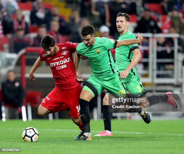 Zelimkhan Bakayev of FC Spartak Moscow vies for the ball with Miral Samardzic and Vladimir Poluyakhtov of FC Anzhi Makhachkala during the Russian...