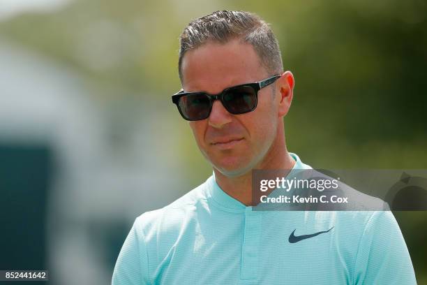 Coach Sean Foley looks on at the range during the third round of the TOUR Championship at East Lake Golf Club on September 23, 2017 in Atlanta,...