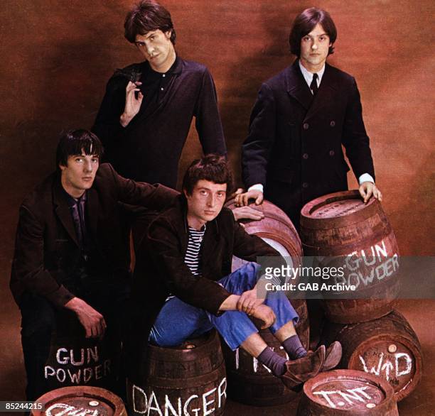 Photo of English rock band The Kinks, posed, studio group shot, sitting on barrels of gunpowder, UK, 1964; they are Mick Avory, Ray Davies , Pete...
