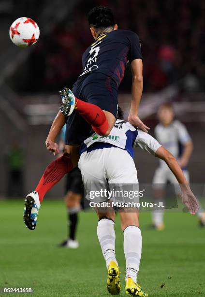 Naomichi Ueda of Kashima Antlers and Shun Nagasawa of Gamba Osaka compete for the ball during the J.League J1 match between Kashima Antlers and Gamba...